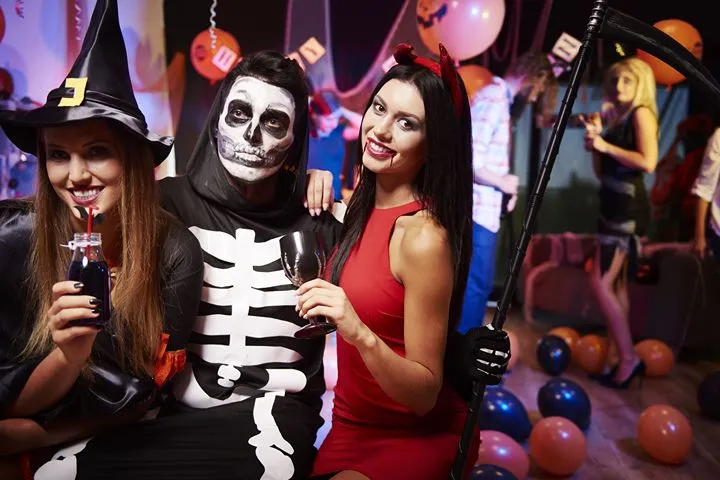 Halloween costumes and decorations at an outdoor celebration